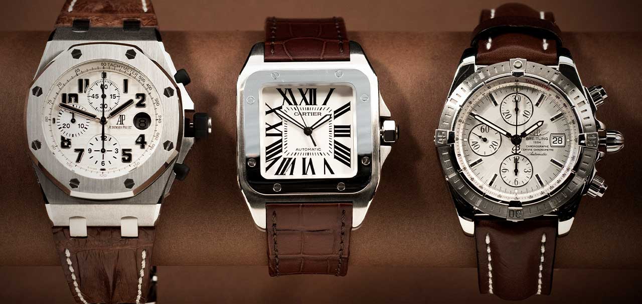 Collection of three luxury watches on display