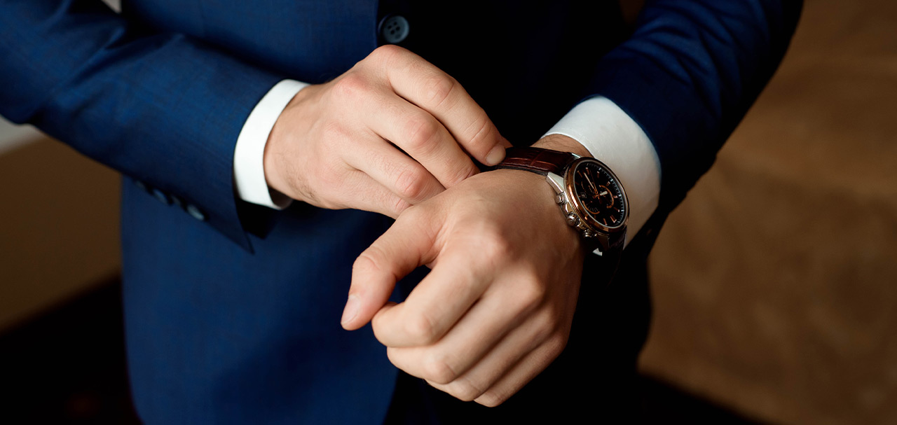 Man in suit putting on Graham watch