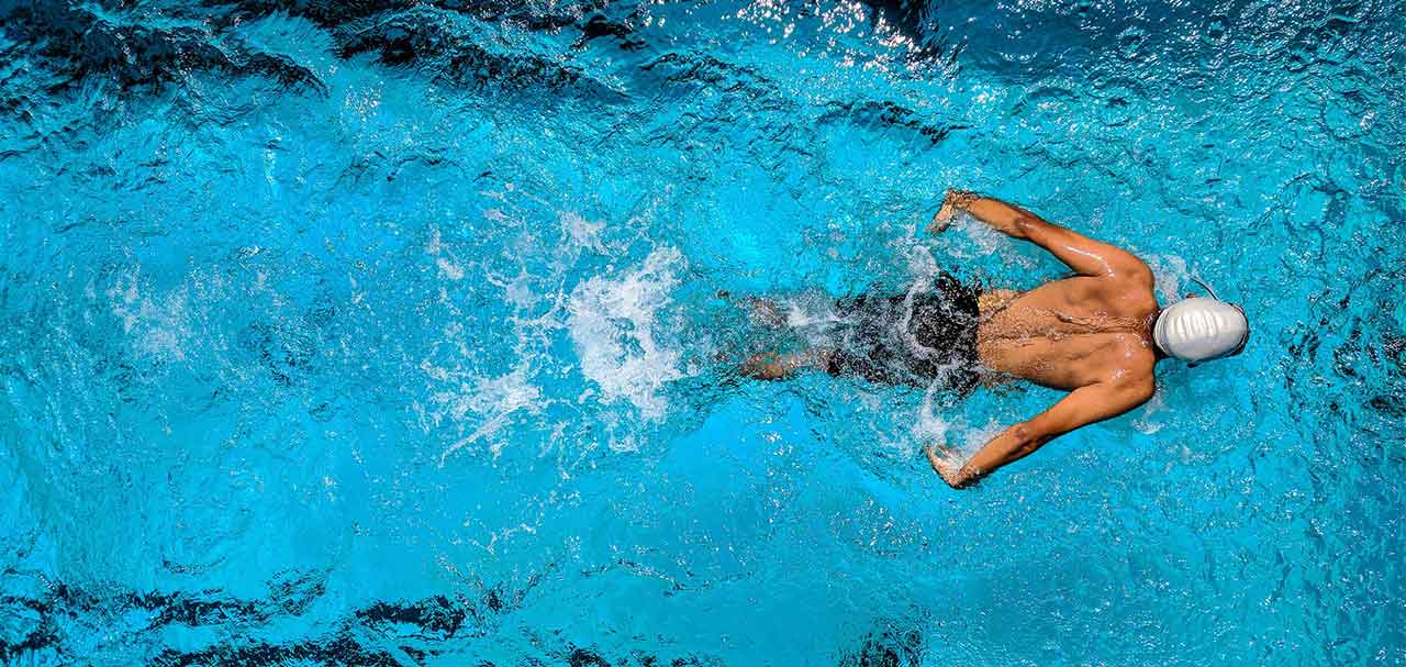 Man swimming for exercise in pool