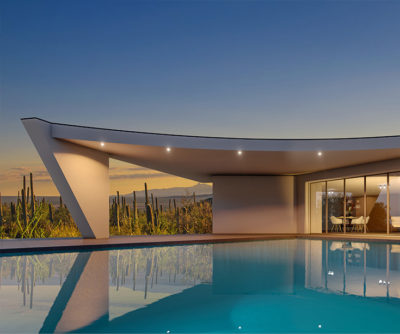 Exterior of a modern, luxury home located in the Sonoran Desert with a reflective pool in the foreground