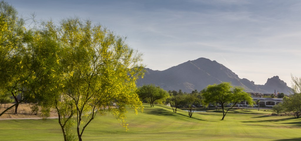View from the fairway of a lush Arizona golf course with Camelback mountain in the background